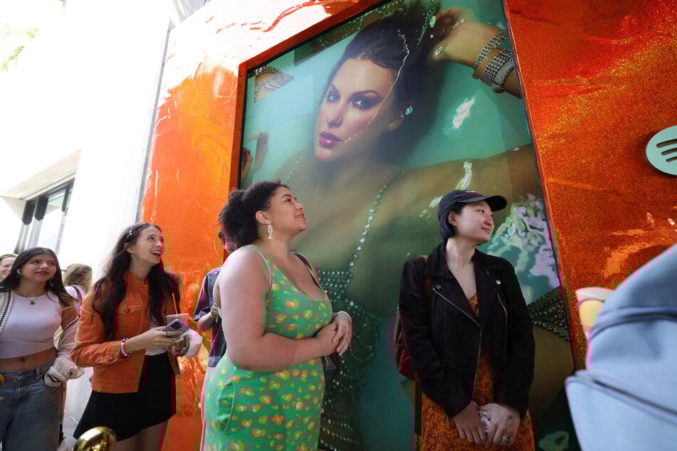 Swifties wait in line to attend a pop-up event at Spotify's three-day immersive experience in New York on Thursday to celebrate Swift's upcoming album The Life of a Showgirl.