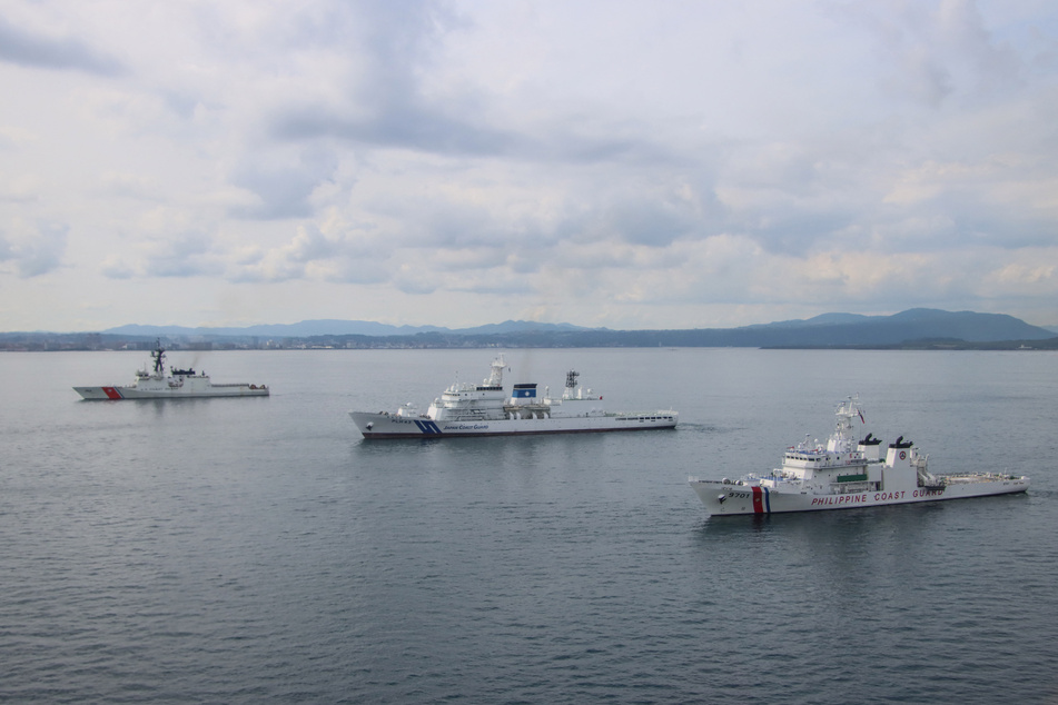 This aerial handout photo taken on Friday and received from the Japan Coast Guard's 10th Regional Coast Guard Headquarters on Saturday shows the Philippine Coast Guard ship Teresa Magbanua (R), the Japan Coast Guard ship Asanagi (C), and the US Coast Guard ship Cutter Stratton (L) in formation during maritime exercises in the waters around the southern city of Kagoshima, Kagoshima prefecture.