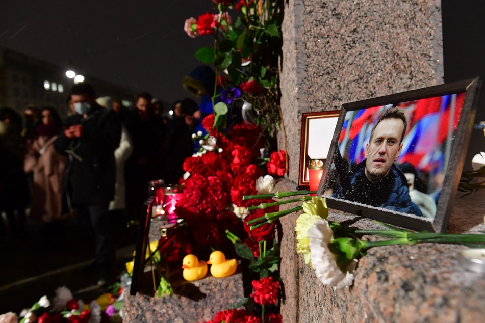 People gather at a makeshift memorial for late Russian opposition leader Alexei Navalny organized at the monument to the victims of political repressions in Saint Petersburg, Russia on Friday.