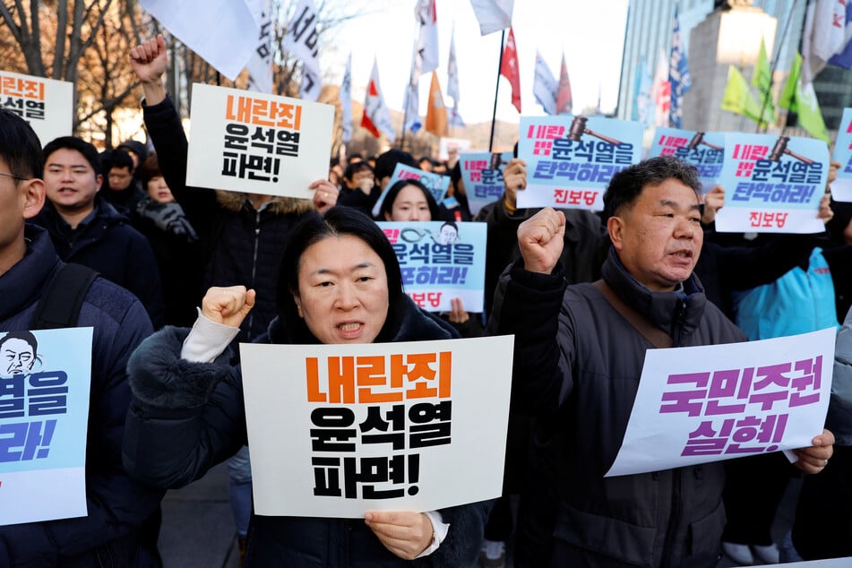 People take part in a rally to demand South Korean President Yoon Suk Yeol's removal from power, in Seoul on December 4, 2024.