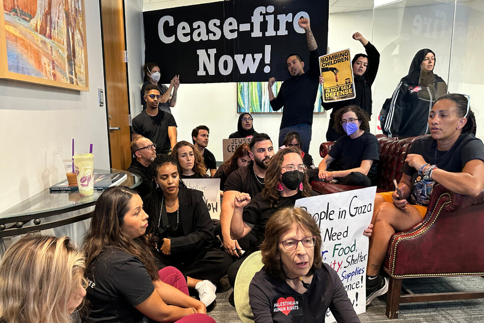 Arizonans hold a peaceful sit-in in the Phoenix office of Democratic Senator Mark Kelly to demand he support a ceasefire now.
