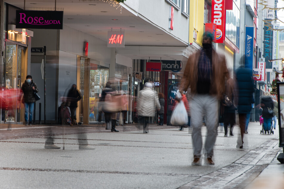 Saarland, Saarbrücken: Menschen gehen mit Mund-Nasen-Bedeckung durch eine Einkaufstraße in der Innenstadt von Saarbrücken.