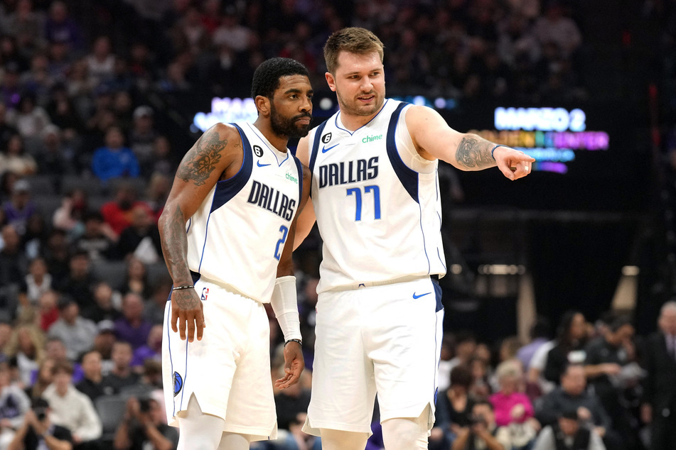 Dallas Mavericks guard Kyrie Irving and guard Luka Doncic talk during the first quarter against the Sacramento Kings at Golden 1 Center.