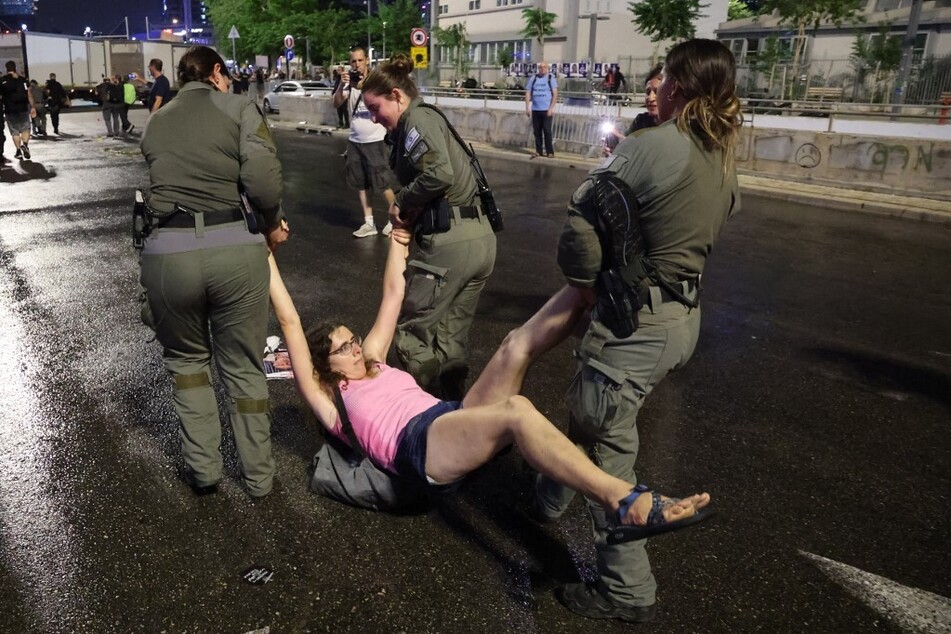 Israeli police detain a protester during a demonstration by relatives and supporters of Israelis taken hostage on October 7.