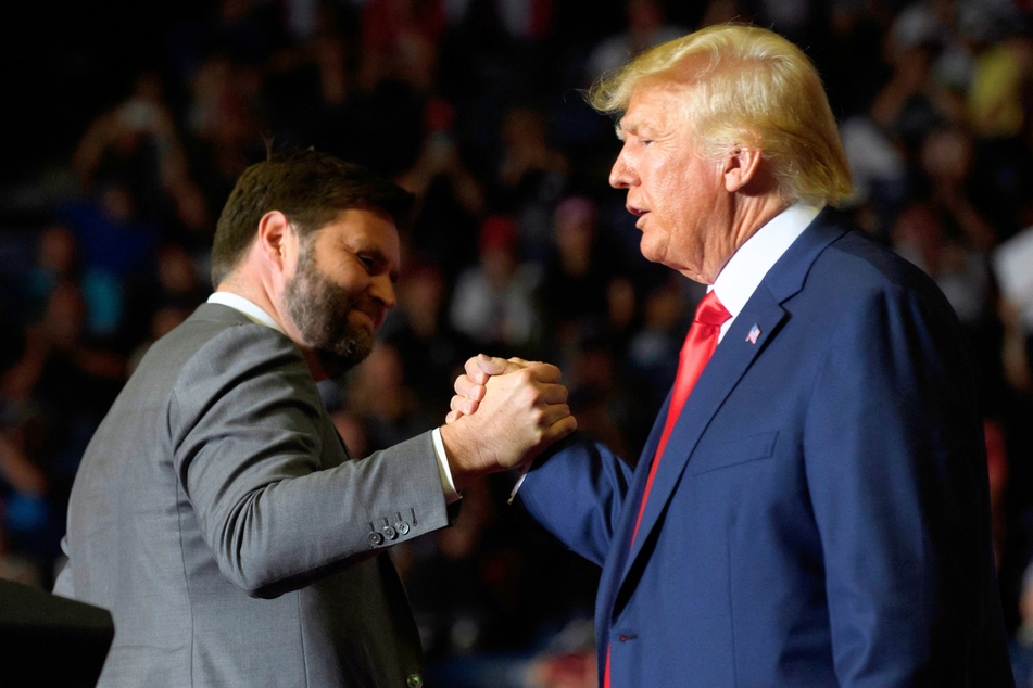 JD Vance (l.) sharing a high-five with Donald Trump during a Save America Rally in Youngstown, Ohio on September 17, 2022.