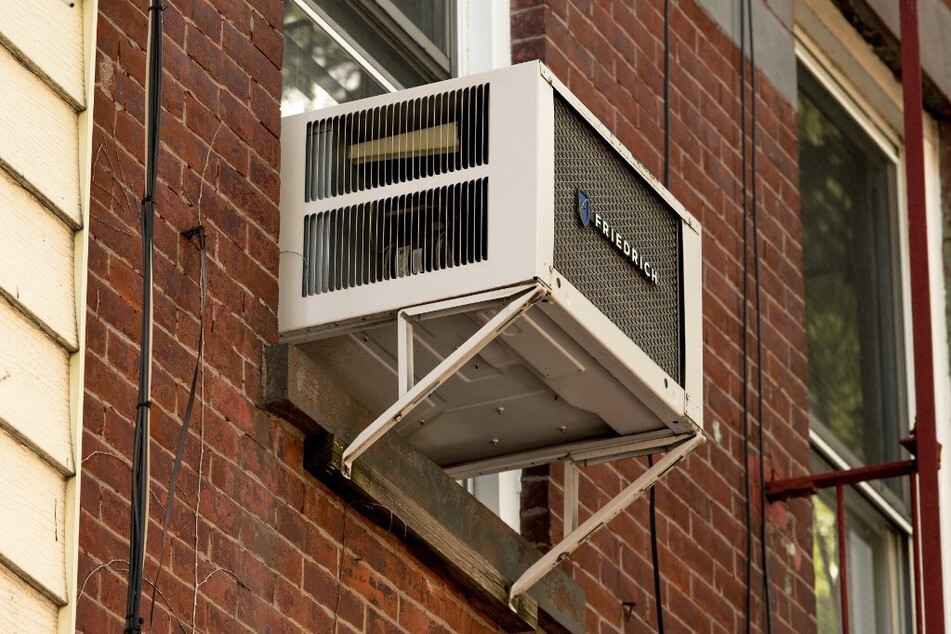 An air conditioner window unit is seen during a heat wave in New York City.