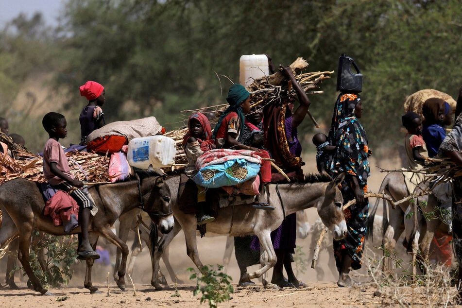 Sudanese refugees who fled the violence in the Darfur region ride their donkeys looking for space to temporarily settle, near the border between Sudan and Chad.