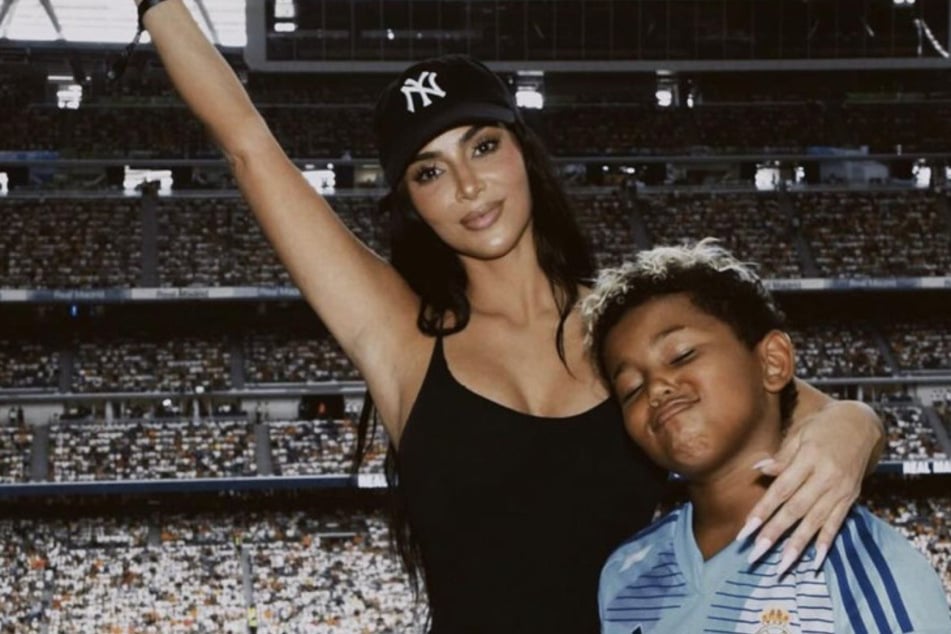 Kim Kardashian is supporting her son Saint's (r.) new YouTube channel by making the budding athlete understand the rules of business.