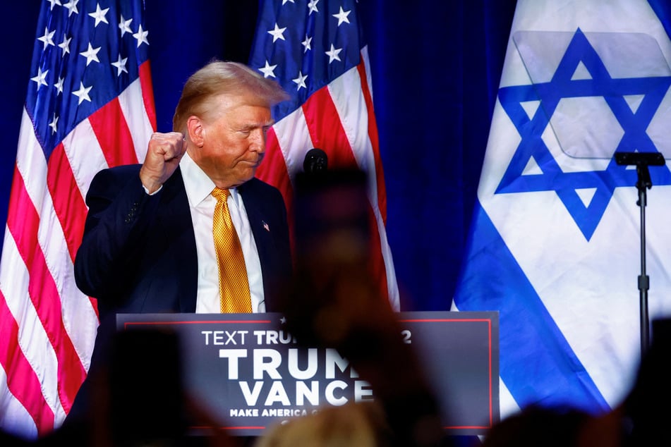 Republican presidential nominee Donald Trump raises his fist during a "Fighting Anti-Semitism in America" event in Washington DC.