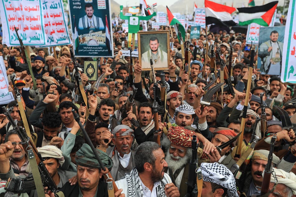 Yemenis raise placards during a rally in solidarity with Palestinians in the Gaza Strip and in condemnation of US strikes, in the Houthi-controlled capital Sanaa on April 25, 2025.