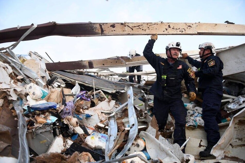 Officials in Matador, Texas, sift through the rubble after a tornado caused severe damage and killed at least four people.