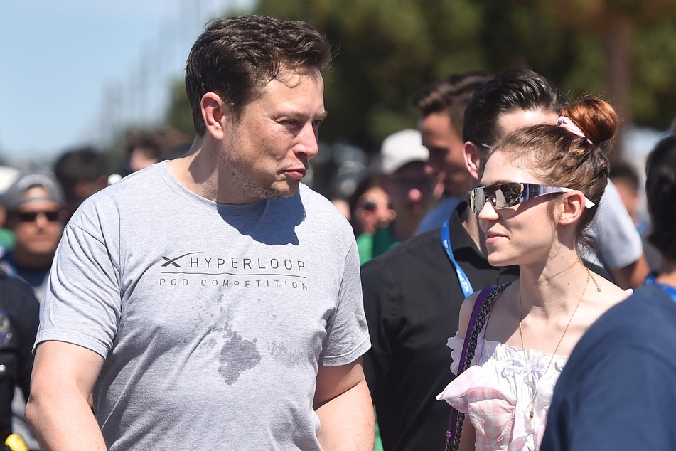 Elon Musk (l.) and Grimes attending the 2018 SpaceX Hyperloop Pod Competition, in Hawthorne, California in July 2018.