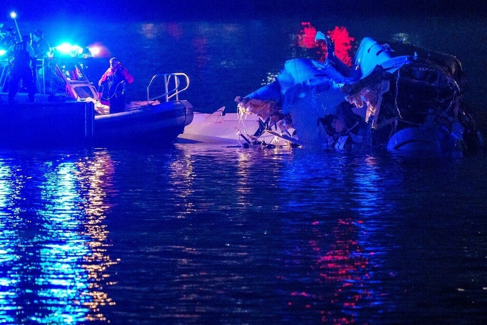 Emergency response teams assess airplane wreckage in the Potomac River near Ronald Reagan Washington Airport.