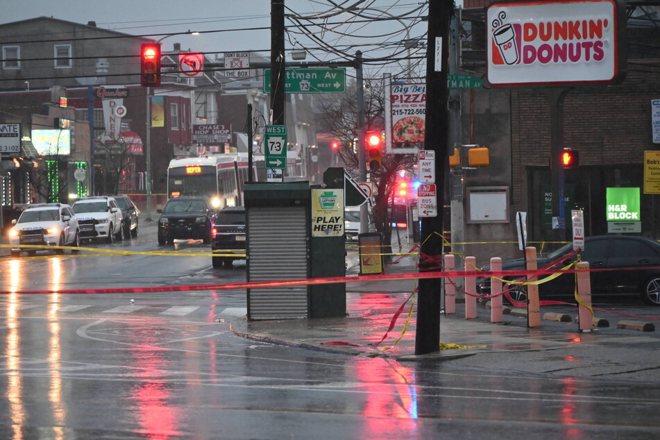 Police tape cordons off the area where eight students were injured in a shooting at a bus stop in northeast Philadelphia, Pennsylvania.