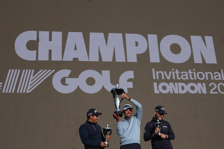 South African golfer Charl Schwartzel celebrates with the trophy after winning the first LIV Golf Invitational.