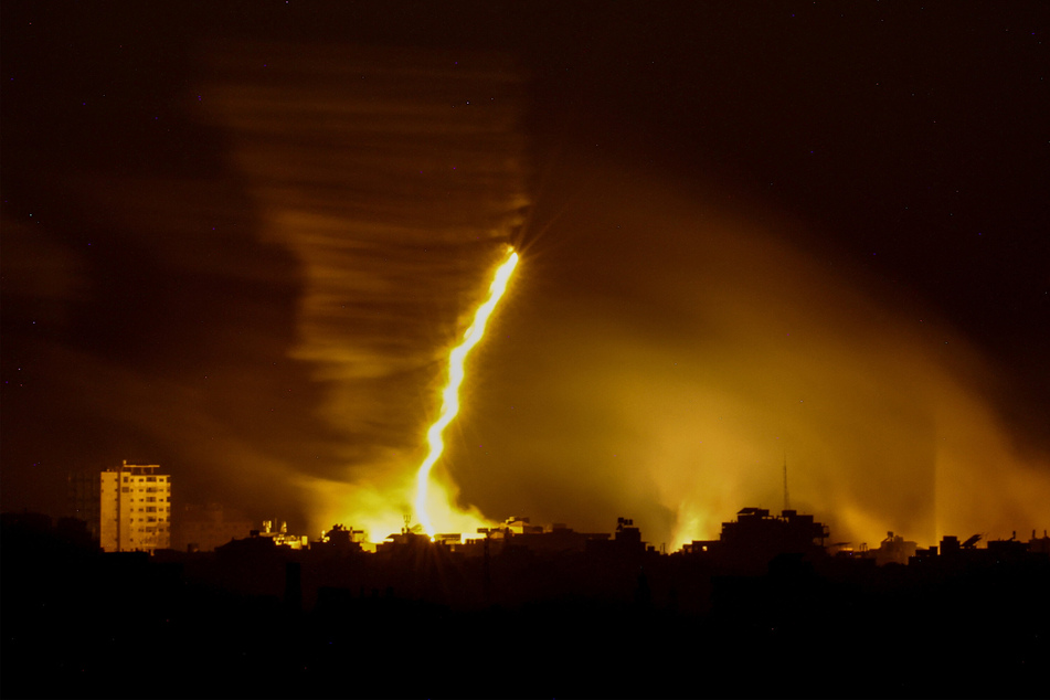 A photo of the Israeli border with the Gaza shows flares being fired by Israeli troops over the Gaza Strip.