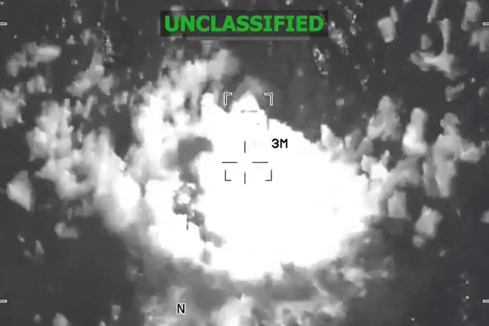 A US military strike on what they said was a suspected drug vessel in international waters, at a location given as the eastern Pacific, is shown in a screen grab from video released by US Southern Command on December 4, 2025.