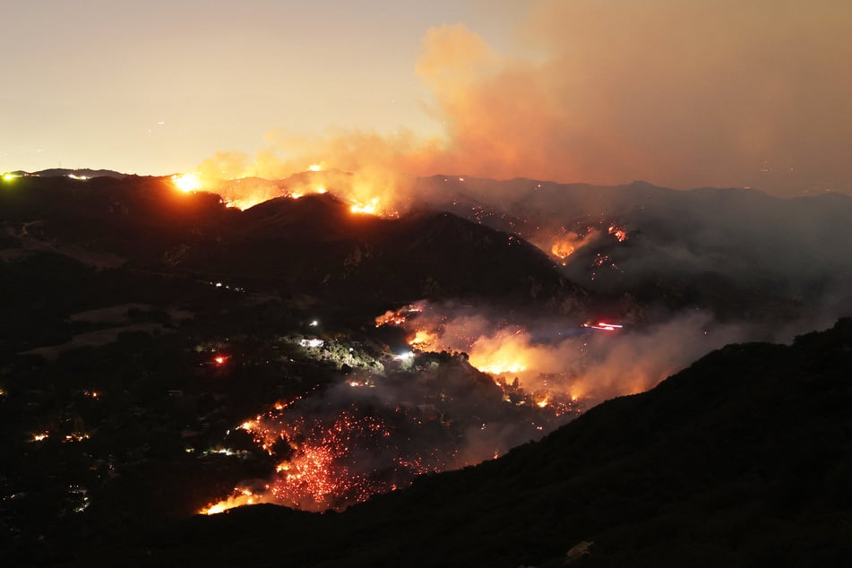 Flames and smoke from the Palisades Fire surround a home in the community of Topanga, California, on Thursday.