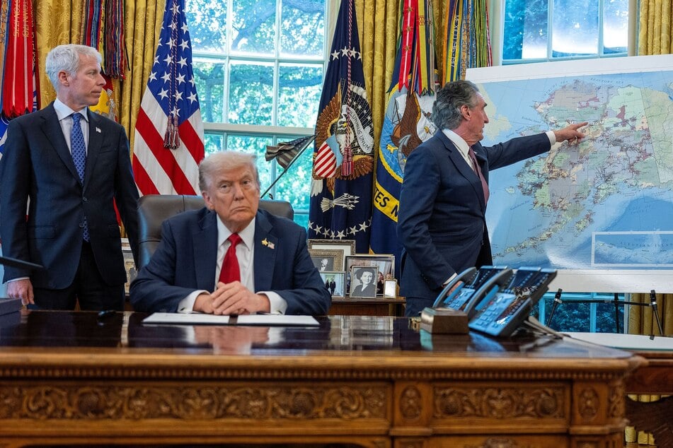 Donald Trump (second from l.) listens as Interior Secretary Doug Burgum (r.) points at a map of Alaska while Energy Secretary Chris Wright (l.) looks on, after the president signed an executive order to authorize the Ambler Road mining project, in the Oval Office of the White House on October 6, 2025.