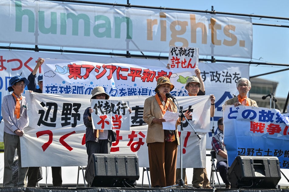 Participants speak against the construction of US military bases in Okinawa, in southern Japan, as they take part in a rally for peace on Constitution Day in Tokyo on May 3, 2024.