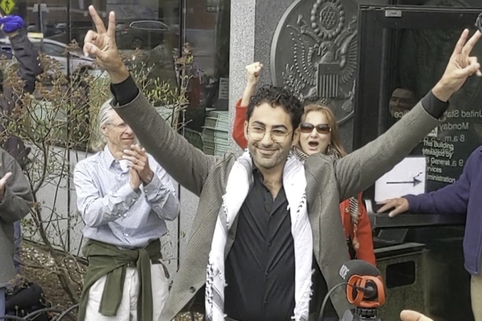 Columbia University student Mohsen Mahdawi gestures in victory as he leaves the federal courthouse after he was released on bail in Burlington, Vermont, on April 30, 2025.