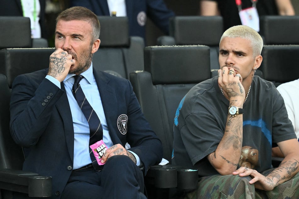 Romeo Beckham (r) took a thinly veiled swipe at his brother Brooklyn by posting what looks like a new tattoo tribute to his family.