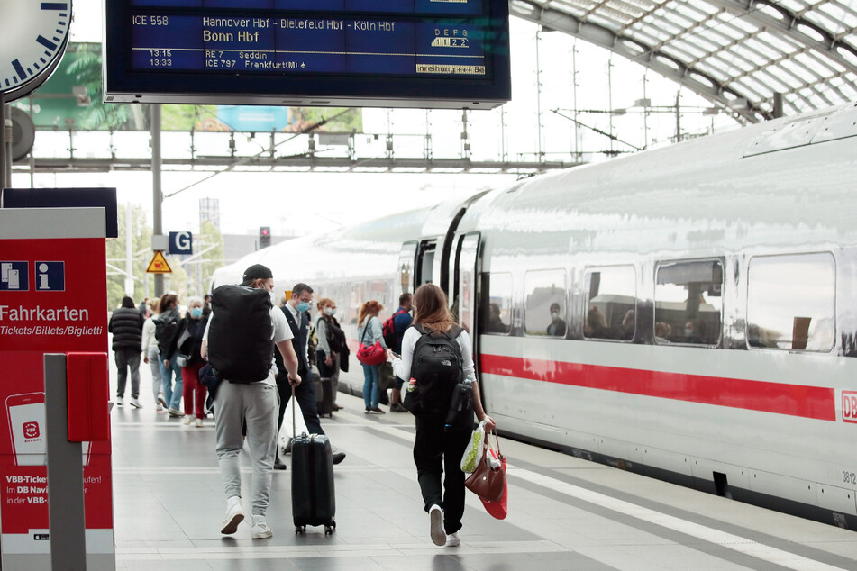 Fahrgäste gehen zu einen ICE-Zug der Deutschen Bahn im Berliner Hauptbahnhof.