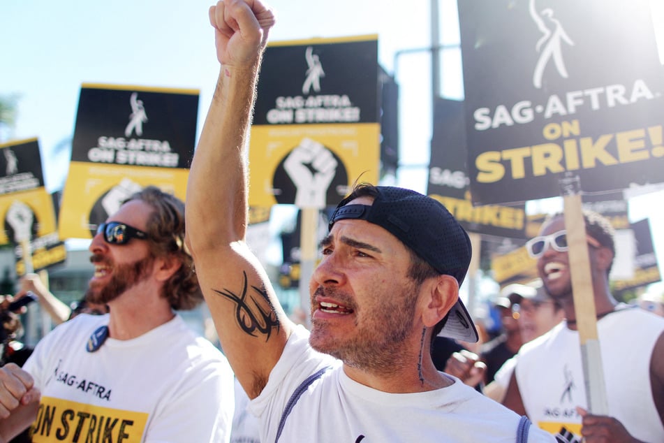 Brandon Alameda raises a fist as SAG-AFTRA members and supporters demonstrate outside Paramount Studios in Los Angeles on day 118 of their strike against the Hollywood studios on November 8, 2023.