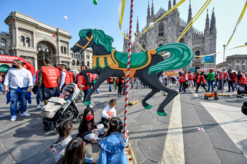 Zirkusmitarbeiter, Kinder und weitere Demonstranten protestieren gegen die Corona-Beschränkungen auf der Piazza Duomo.