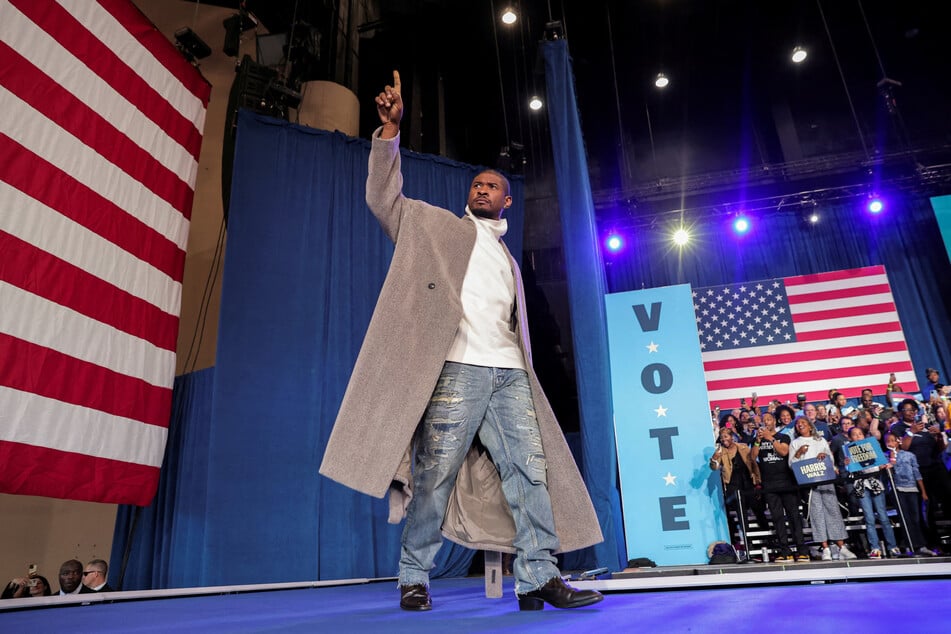 Usher gestures onstage during a campaign event for Vice President Kamala Harris in Atlanta, Georgia, on October 19, 2024.