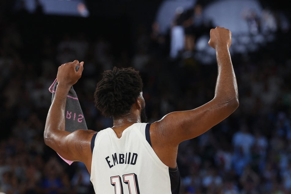 Joel Embiid of Team USA celebrates after winning the men's basketball semifinal match against Serbia at the Paris Olympics.