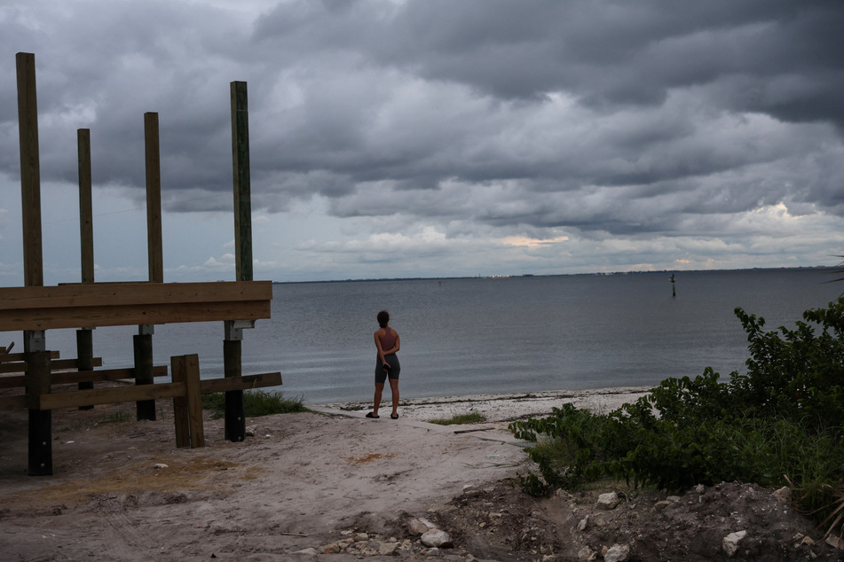 Nyasia Arzuaga looks out at storm clouds as Hurricane Ian nears Florida.