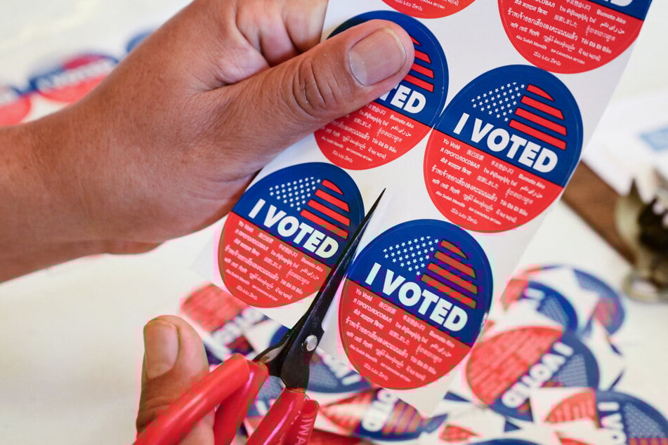 "I Voted" stickers are being prepared at a vote center in Los Angeles, where Proposition 50 is the only measure in the state’s special election.