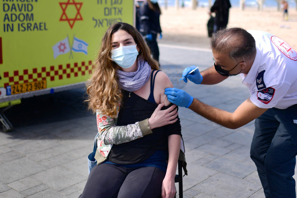 Eine israelische Frau wird in einer provisorischen Einrichtung in Tel Aviv des israelischen Rettungsdienstes Magen David Adom gegen das Coronavirus geimpft. Fast 62 Prozent der 9,3 Millionen Landesbewohner haben bereits eine erste Corona-Impfung erhalten, fast 56 Prozent auch die zweite Dosis.
