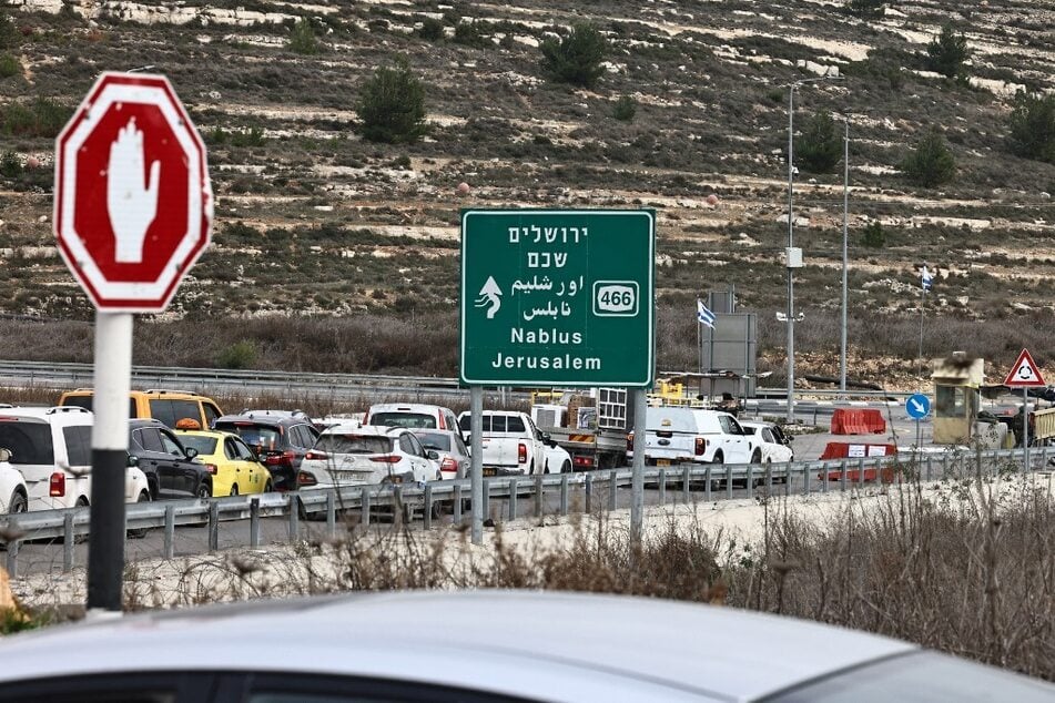 Commuters wait in their vehicles at the Israeli Atara checkpoint on route 465 near Ramallah in the occupied West Bank on January 22, 2025.