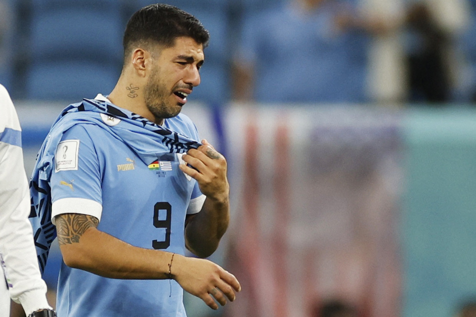 Uruguay striker Luis Suárez leaves the pitch in tears after his team's elimination.