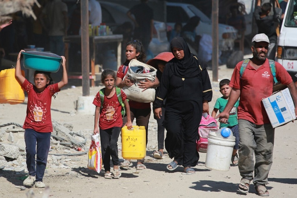 Displaced Palestinians leave an area in east Khan Younis towards the west, after the Israeli army issued a new evacuation order for parts of the southern Gaza city.