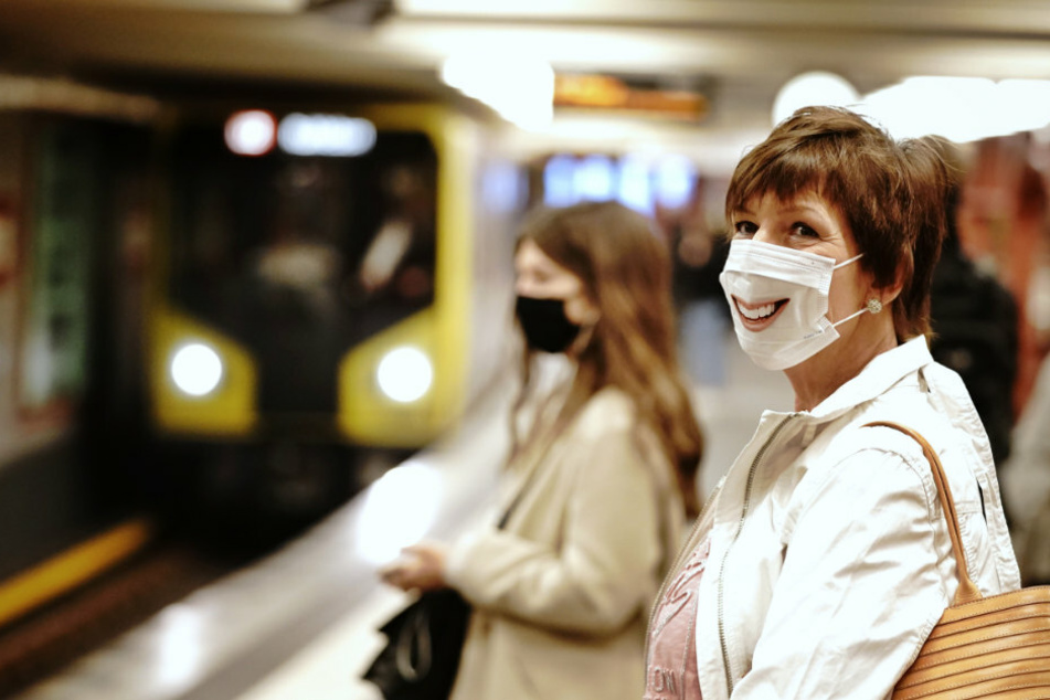 Fahrgäste mit Mund-Nasenschutz stehen am Morgen an der U-Bahnhaltestelle Alexanderplatz.