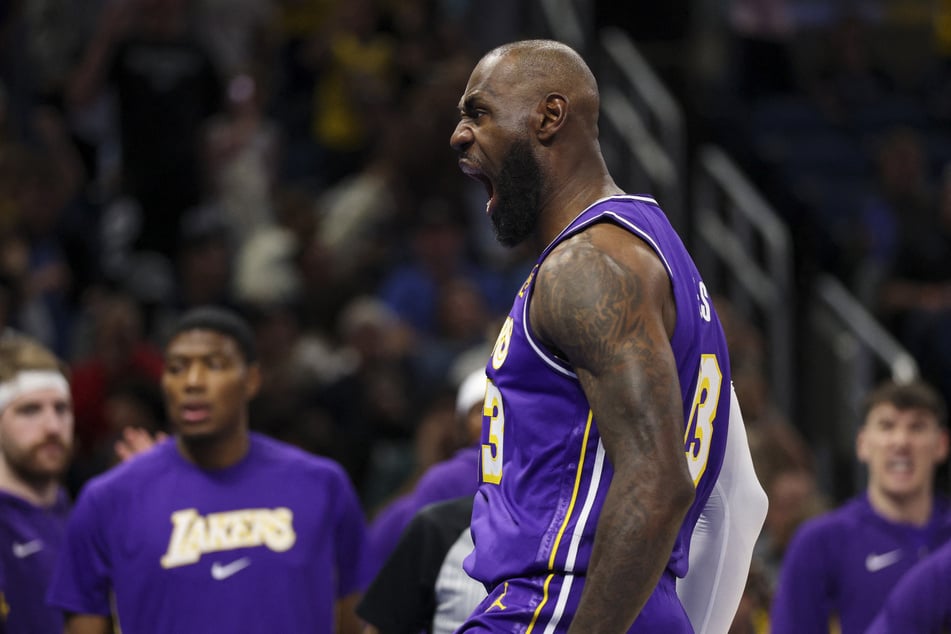 Los Angeles Lakers forward LeBron James reacts after dunking the ball against the Orlando Magic in the first quarter at Kia Center on March 21, 2026.
