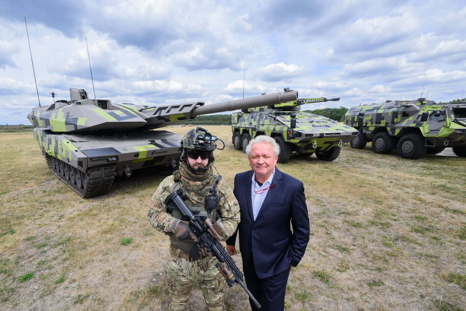 Rheinmetall-Vorstandsvorsitzender Armin Papperger und ein Soldat vor einem Kampfpanzer vom Typus Panther.