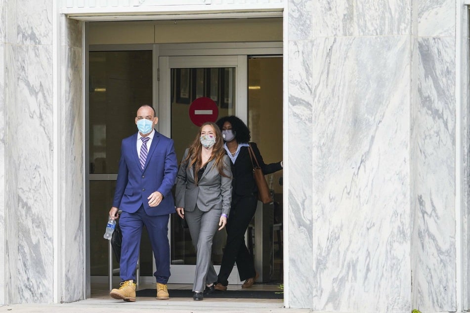 Lawyer Susan Friedman (2nd from left) leaves the public prosecutor's office together with her client Robert DuBoise (l.) after a hearing to exonerate DuBoise, who was acquitted after spending 37 years in prison.