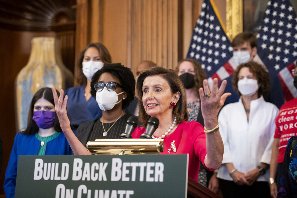 Nancy Pelosi at a press conference, advocating for climate provisions in the Build Back Better plan.
