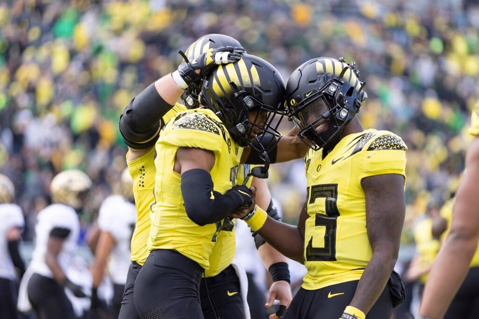 Troy Franklin of the Oregon Ducks celebrates a touchdown with teammate Anthony Brown against the Colorado Buffaloes at Autzen Stadium.
