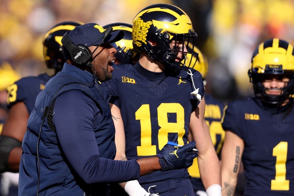 Head coach Sherrone Moore (l.) made a promise to uphold Michigan football's dominance, but the road ahead doesn't look promising.