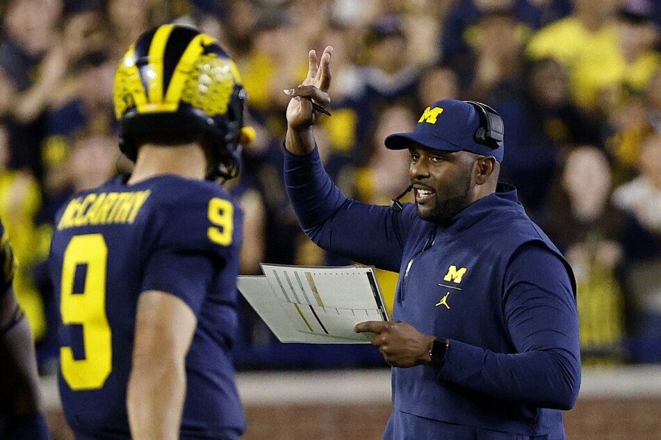 With Jim Harbaugh set to steal Michigan coaches over to the NFL, Sherrone Moore (r.) must now find quick answers to the Wolverines' coaching vacancies.