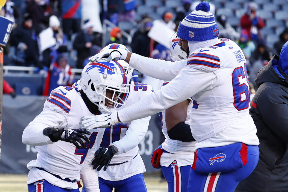 Buffalo Bills players celebrate after making an interception in their title-clinching win over the Chicago Bears.