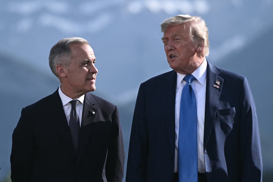 Canadian Prime Minister Mark Carney (l.) and US President Donald Trump pose for a family photo during the Group of Seven Summit at the Kananaskis Country Golf Course in Alberta, Canada, on June 16, 2025.