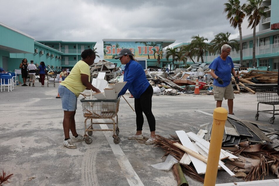 People continue to clean up from Hurricane Helene as preparations are made for Hurricane Milton's arrival in Treasure Island, Florida.