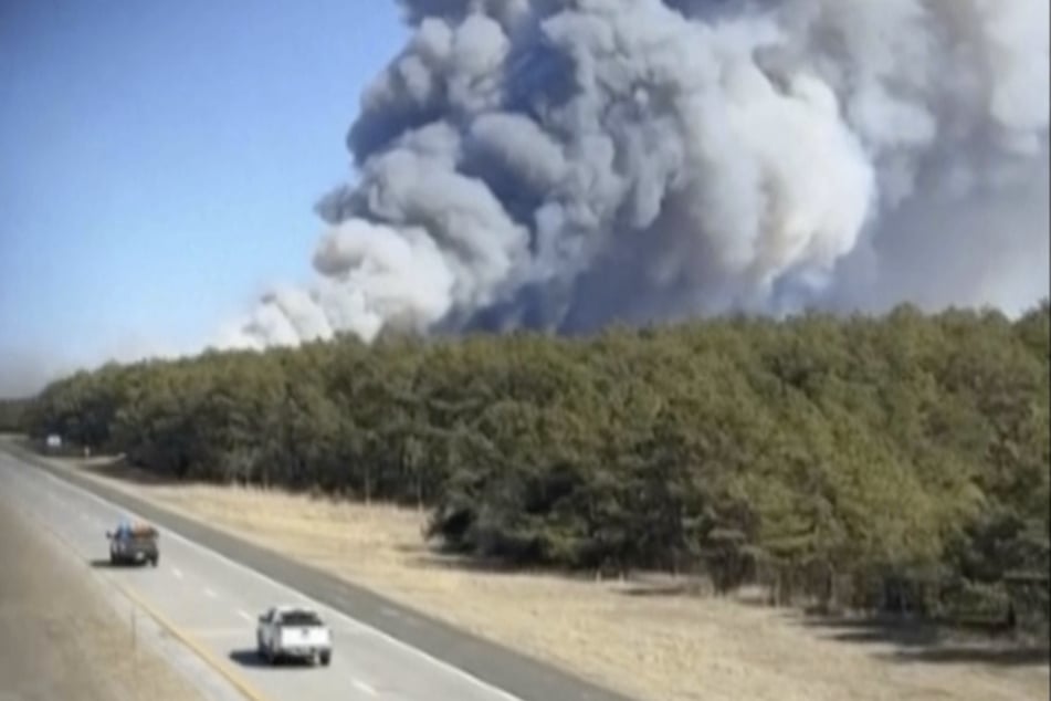 Thick clouds of smoke drift over the city.