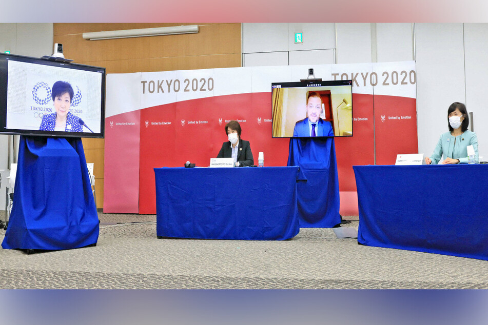 The four-party talks ahead of Tokyo Paralympics on Monday included the head of the Tokyo Olympic and Paralympic organizing committee Seiko Hashimoto (seated, l.), Japan's Olympic minister Tamayo Marukawa (seated, r.), International Paralympic Committee President Andrew Parsons (in r. screen), and Tokyo Gov. Yuriko Koike (in l. screen).